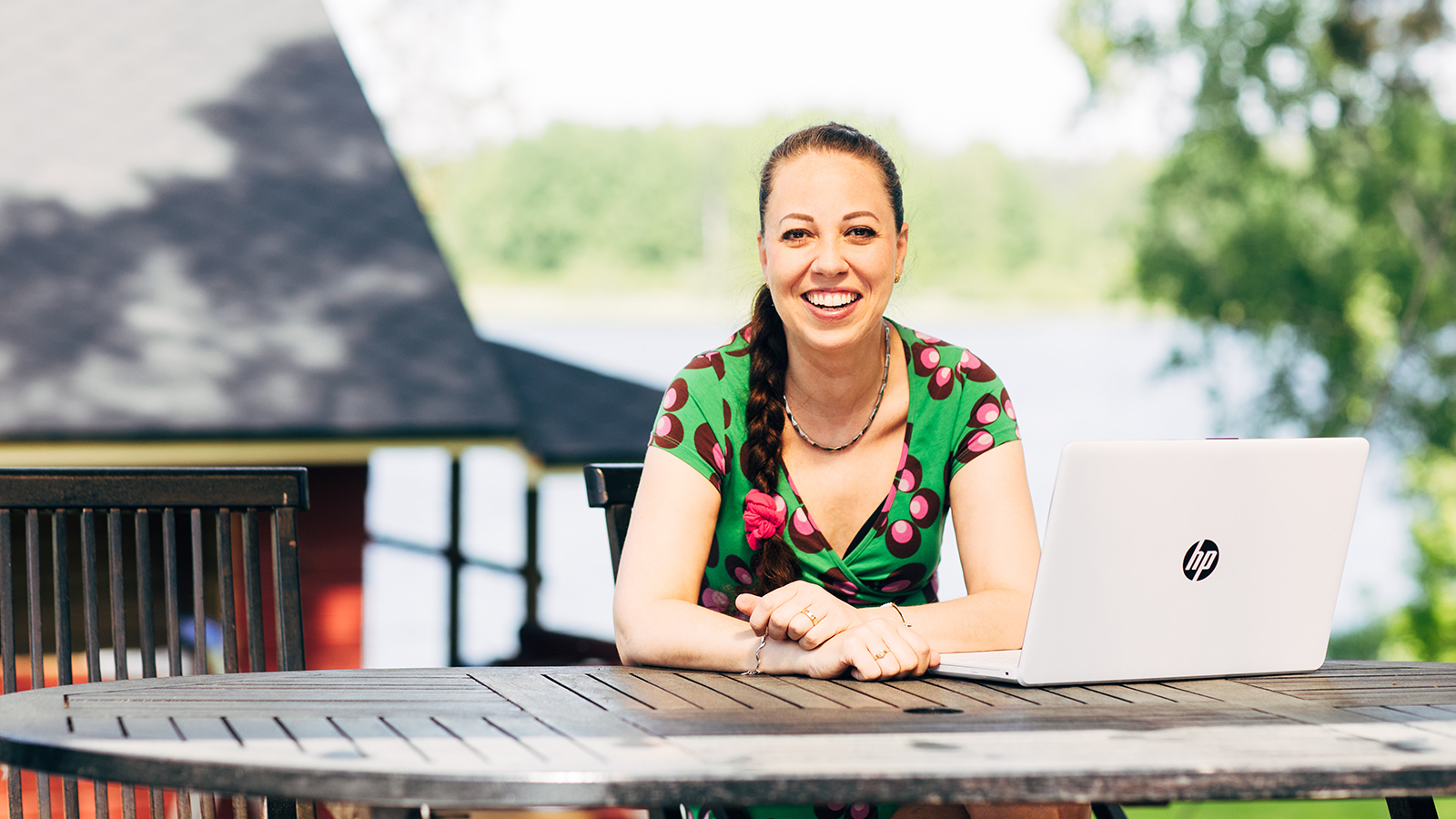 Heidi Koivisto sitter på stuggården vid datorn.